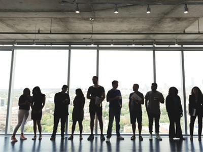 A Group of People Standing in Front of a Glass Wall