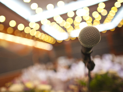 A Microphone on a Stage With Blurry Background