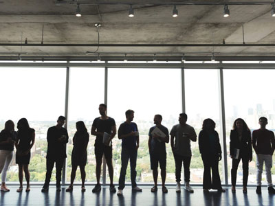 A Group of People Standing in Front of a Glass Wall