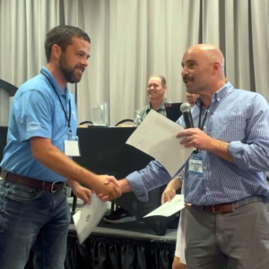 Inspector Training Committee members shaking hands at a meeting.